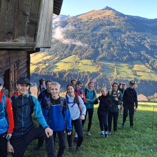 Schüler vor einer Holzhütte